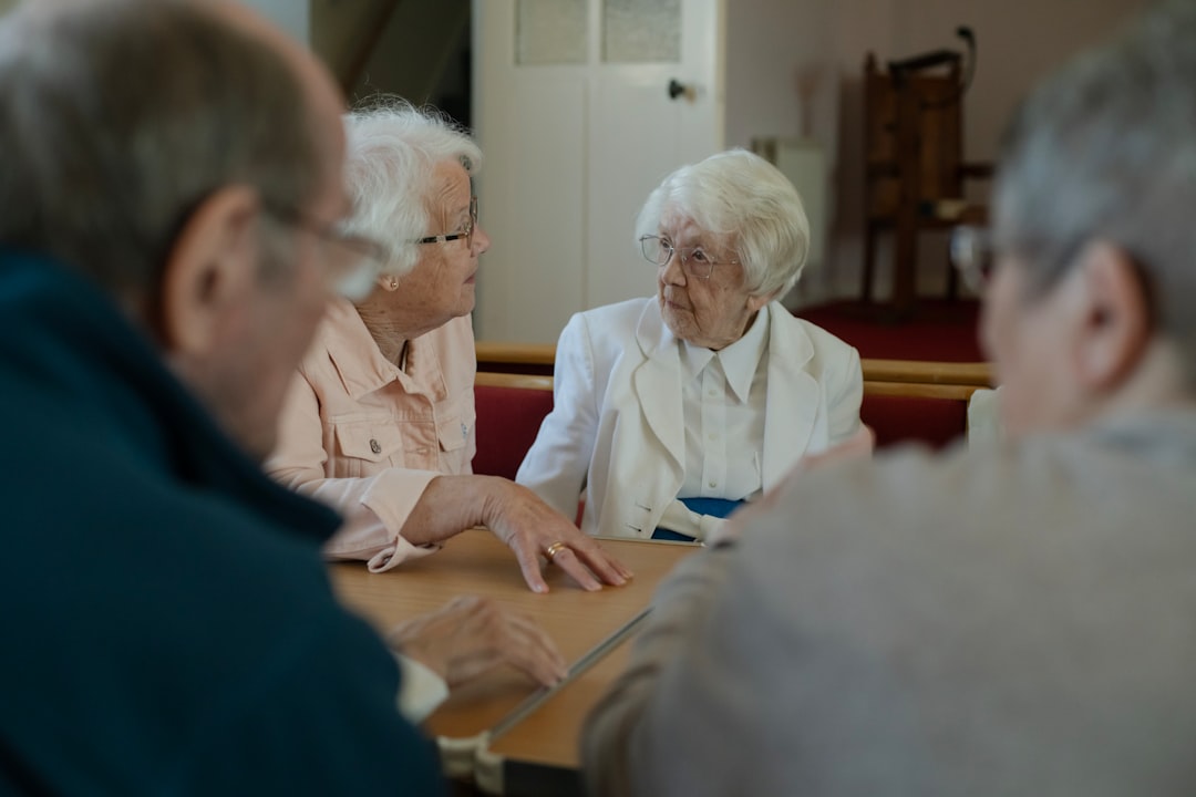 Older people enjoying community time together over tea